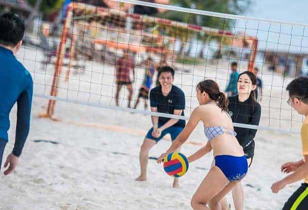 people playing beach volleyball on redang sandy beach