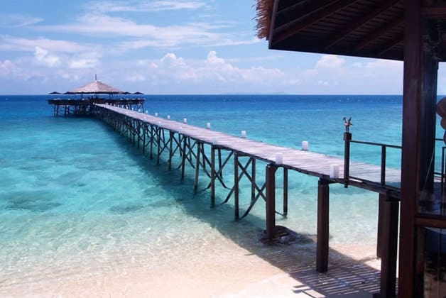 tioman island wooden bridge above crystal clear water in sunny day
