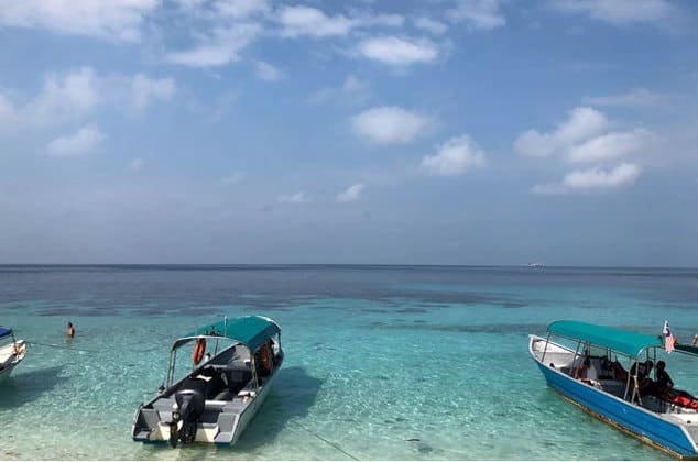 two empty speedboats resting on tioman island beach side