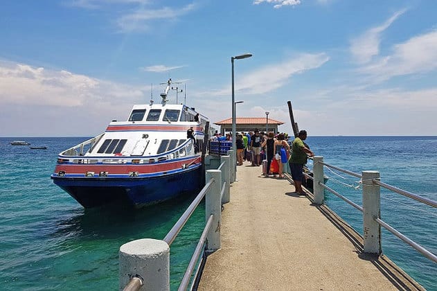 tourists boarding ferry on tioman island jetty