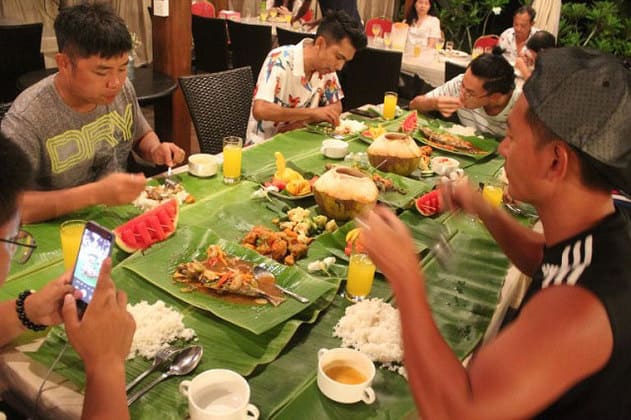 tourists eating dinner in bayu lestari resort pulau besar