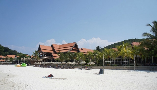 laguna redang resort building on beach with palm trees in a sunny day