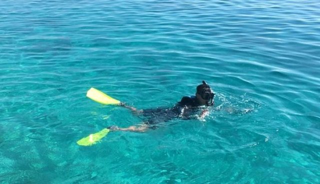 man snorkeling at clear sea water of lang tengah island