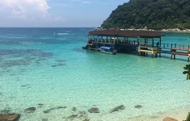 perhentian island jetty with awning above clear sea water