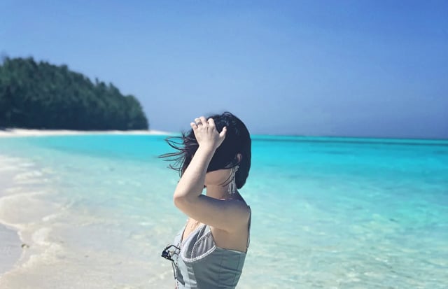 short hair woman standing on beach of perhentian island