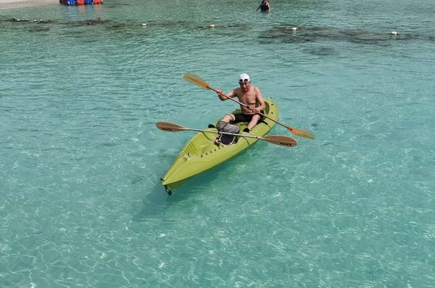 a man kayaking on clear water of perhentian island