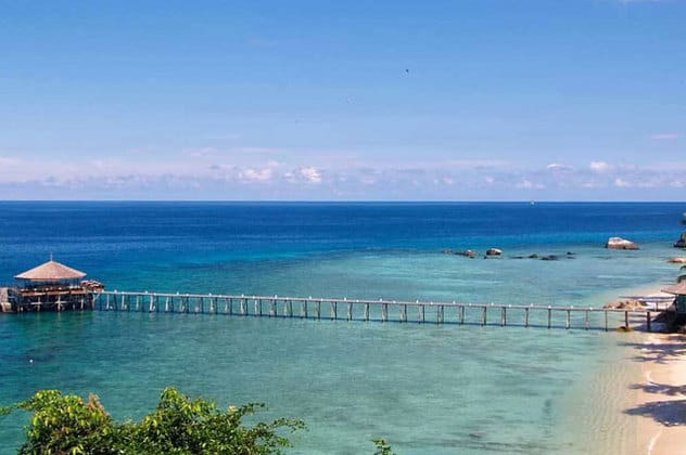 pulau tioman island jetty wooden bridge above clear sea water