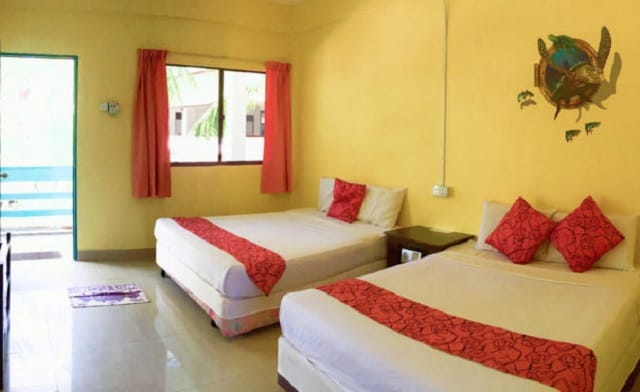 redang bay resort quad room interior with two queen beds