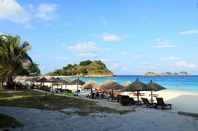 a line of plenty big straw umbrellas on redang island beach access 