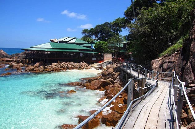 wooden bridge leads to redang island reef resort along sea shore