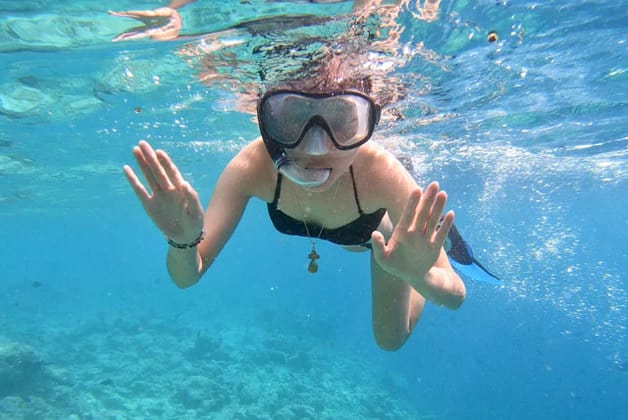 woman snorkeling at perhentian island clear sea water with mask and snorkel