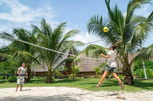 men playing beach volleyball in pulau besar island beach