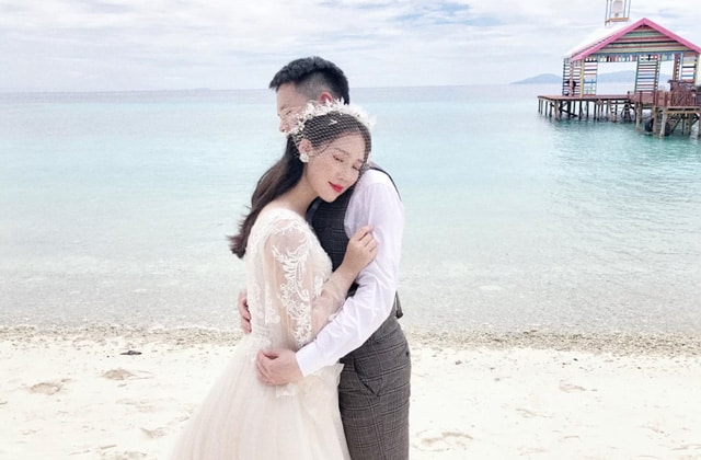 couple taking wedding photo on beach of sibu island