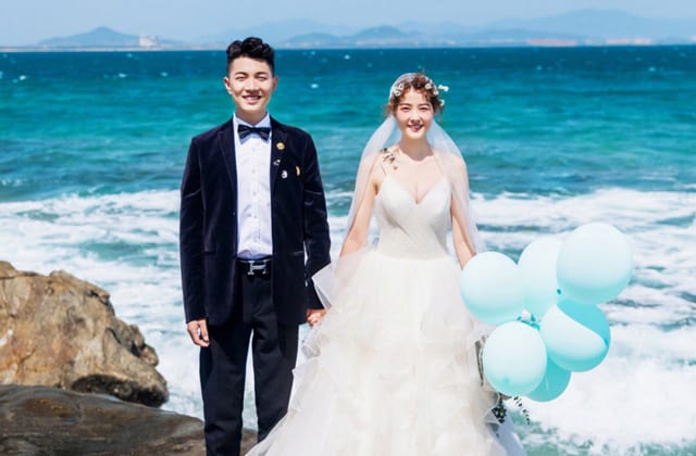 couple in wedding dress standing on beach of kapas island