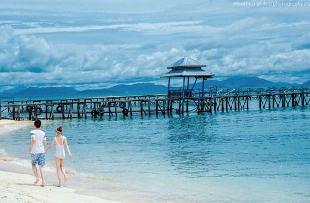 couple walking on beach of sibu island