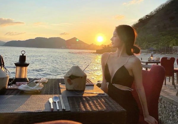woman having dinner at sunset on aur island beach