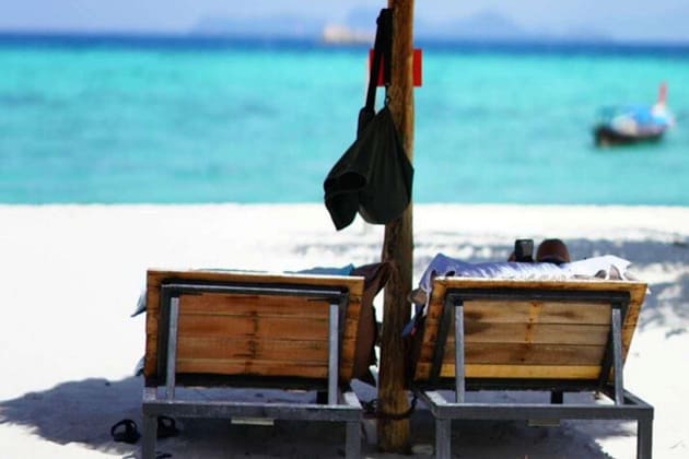 two empty deck chairs on beach of koh lipe island