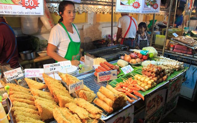 woman selling fried food in koh lipe walking street food stalk