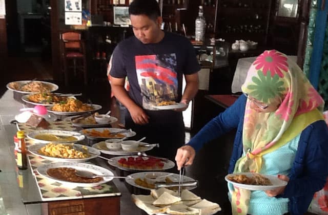 tourists in Lanting Beach Resort having buffet lunch in Pemanggil Island