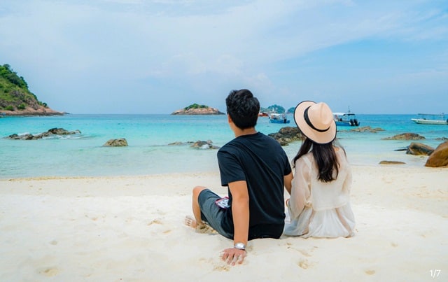 redang island resort beach couple sitting