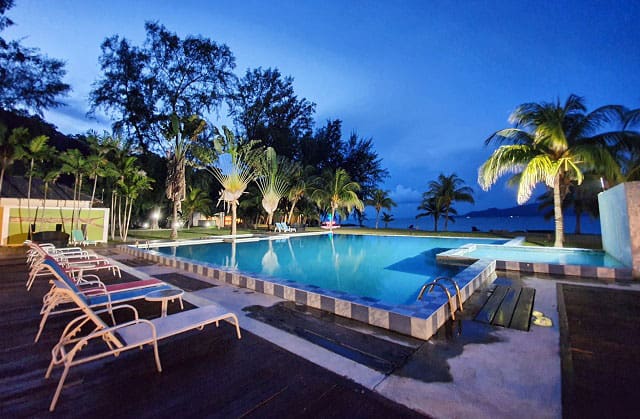 outdoor swimming pool at night in sari pacifica beach resort and spa sibu island