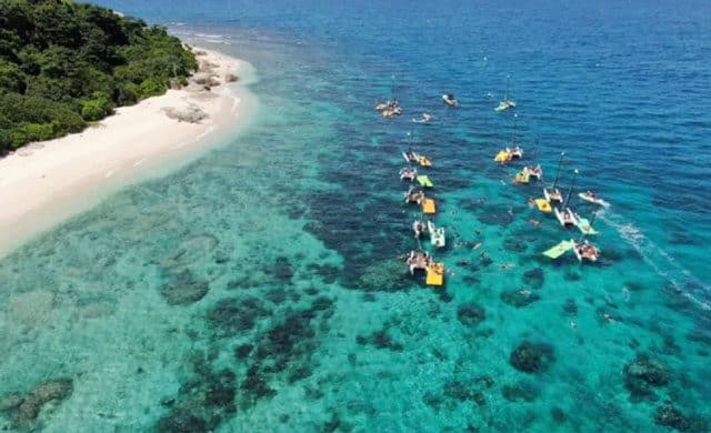 aerial shoot of tenggol island clear sea water with some boats roaming