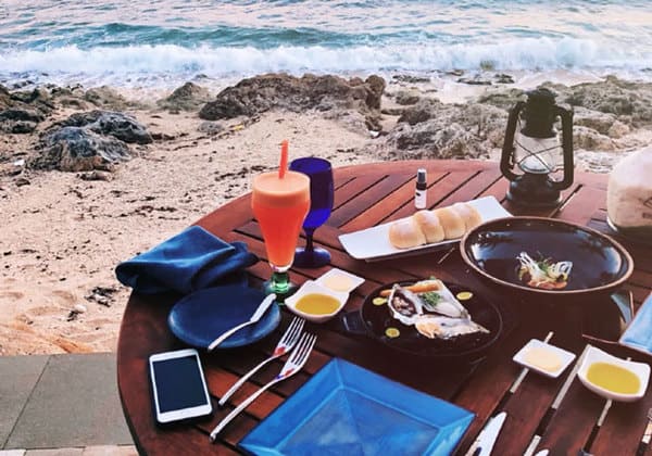 breakfast table setting on beach of tenggol island