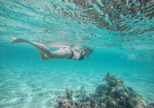 woman in bikini snorkeling in tenggol island