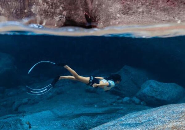 woman with fins snorkeling in tenggol island seawater