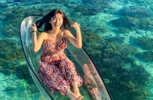 girl sitting transparent boat sipadan mabul sea