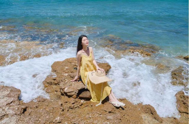 malaysia island woman yellow dress sitting rock